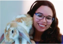 A woman holding a rabbit in her arms
