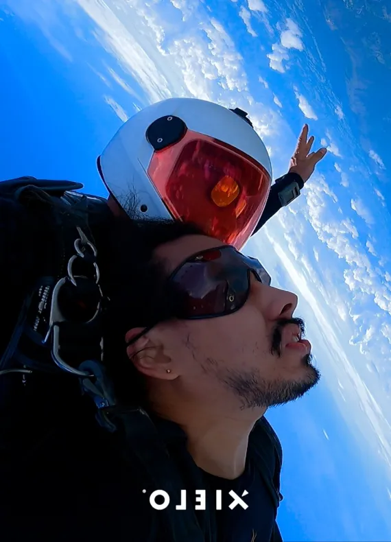 A man flying through the air while wearing a helmet