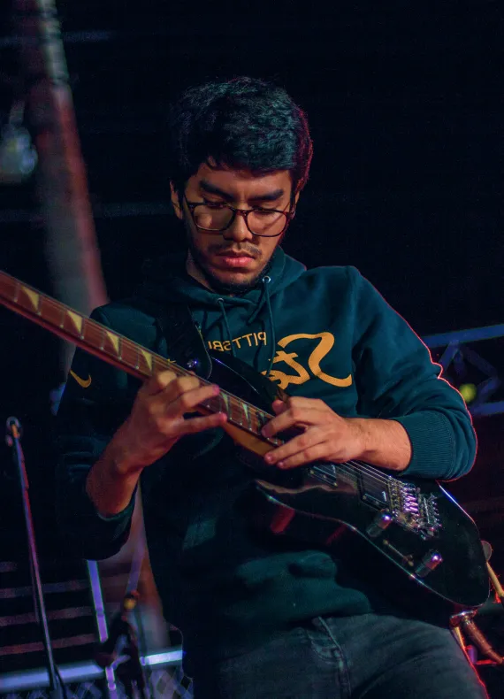 A man playing a guitar on a stage